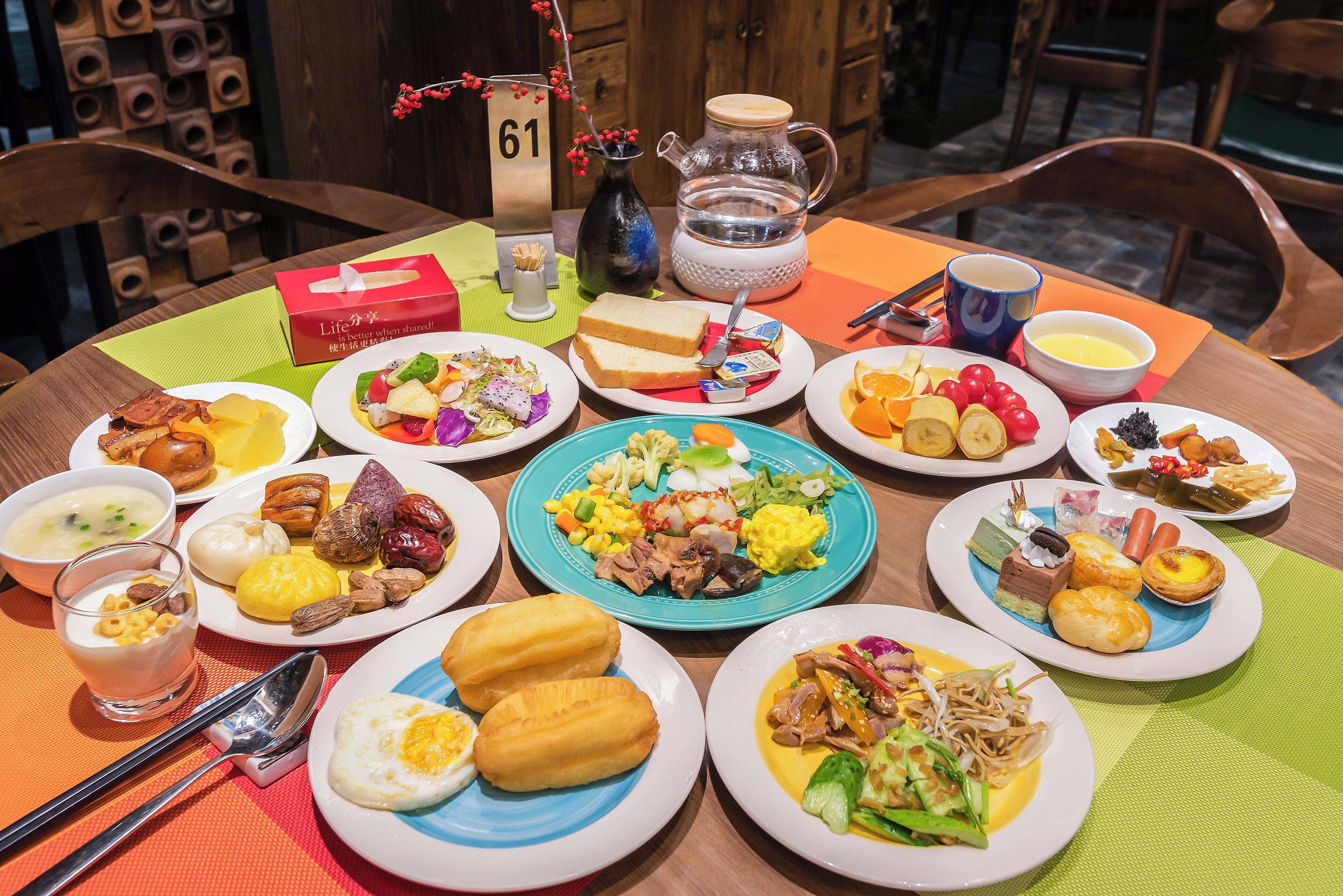 A table set with various dishes, including eggs, meats, and vegetables, indicating a meal setting.