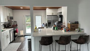 Enjoy cooking in this well-equipped kitchen with a central island, bar stools, and ample counter space.