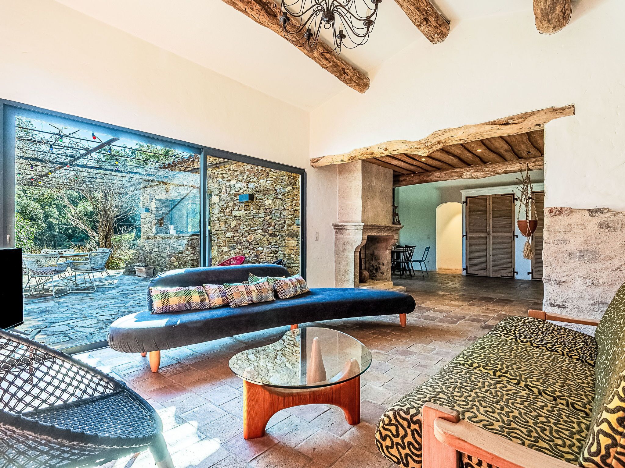 A spacious living area with a stone wall, a large window, and a view of the outdoors.