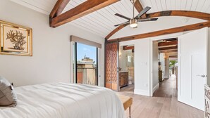 A bedroom with a bed, a ceiling fan, and a view of the outside. - New! Bayfront 3 BD/3BA Retreat with Private Patio! (San Diego)