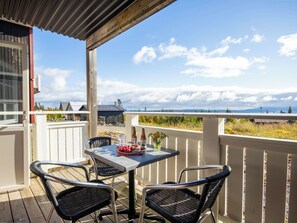 A balcony with a table and chairs, overlooking a scenic landscape. - Trillevallen 1 by Interhome (Trillevallen)