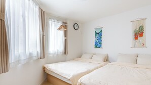 A bedroom with two beds, a window with curtains, a clock, and a wall art piece. - 22 min to EXPO,15 min to KITA-Osaka/Umeda: HepFive,KuchuTeien,Kitashinchi (Osaka)