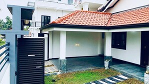 A modern two-story house with a red-tiled roof, a covered patio, and a gated entrance. - Grand Airport Transitt (Negombo)