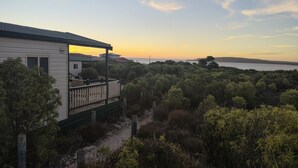 A house with a balcony overlooking a forested area and a body of water in the distance. - Elliston Waterloo Bay Tourist Park  (Elliston)
