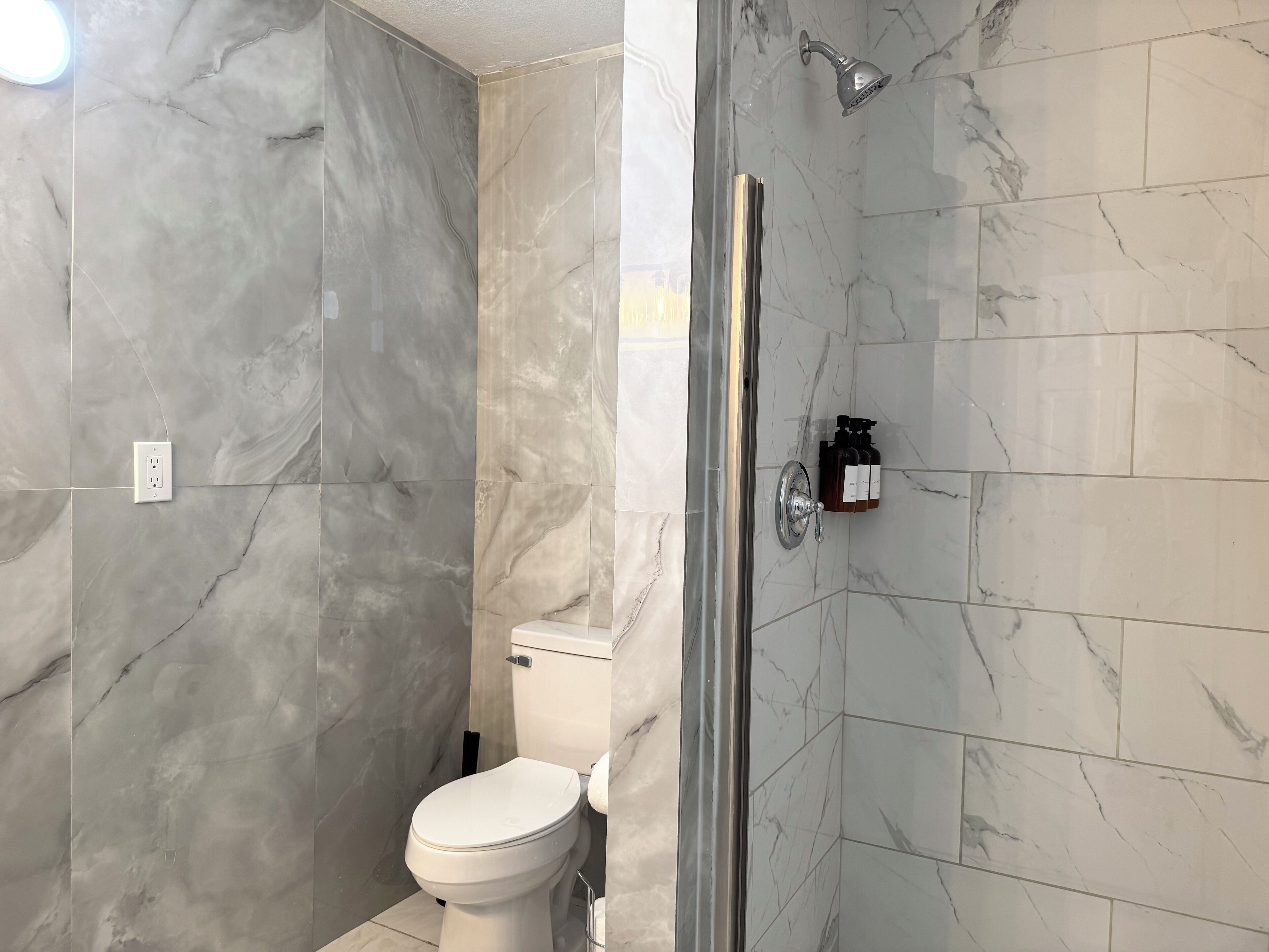 Shower, hair dryer, towels, shampoo