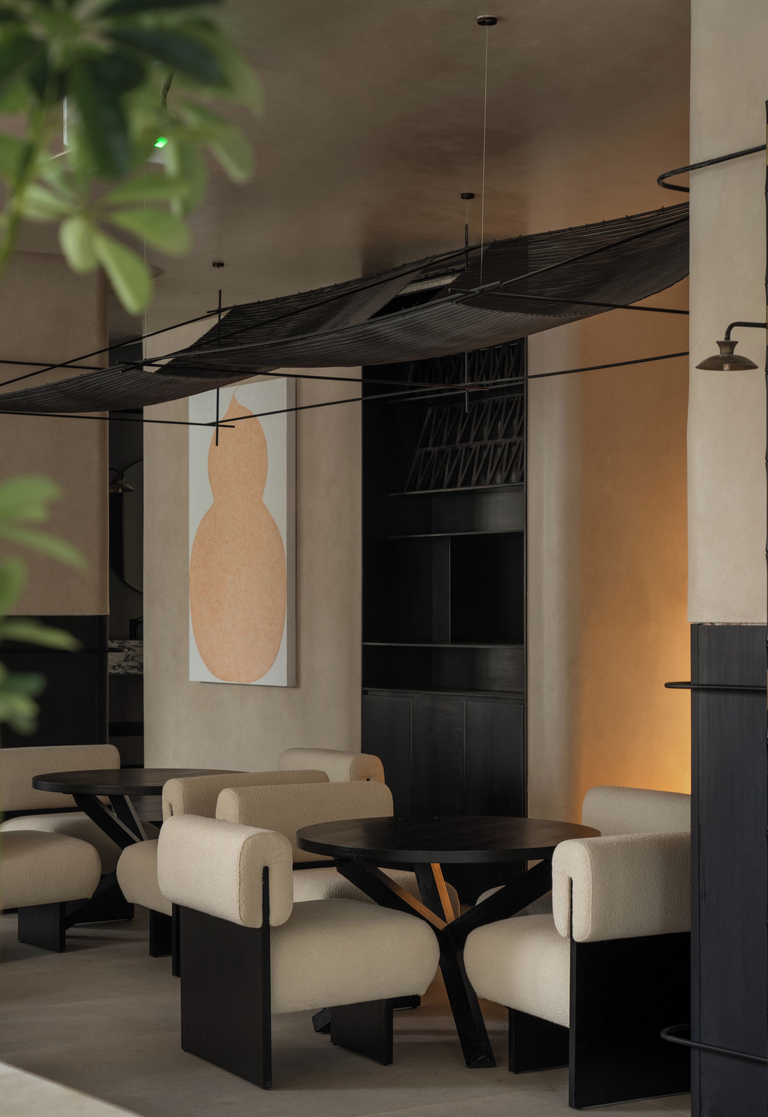 A modern interior with a sofa set, a round table, and a large abstract painting on the wall.