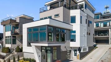 A modern multi-story residential building with large windows, balconies, and a well-maintained exterior.