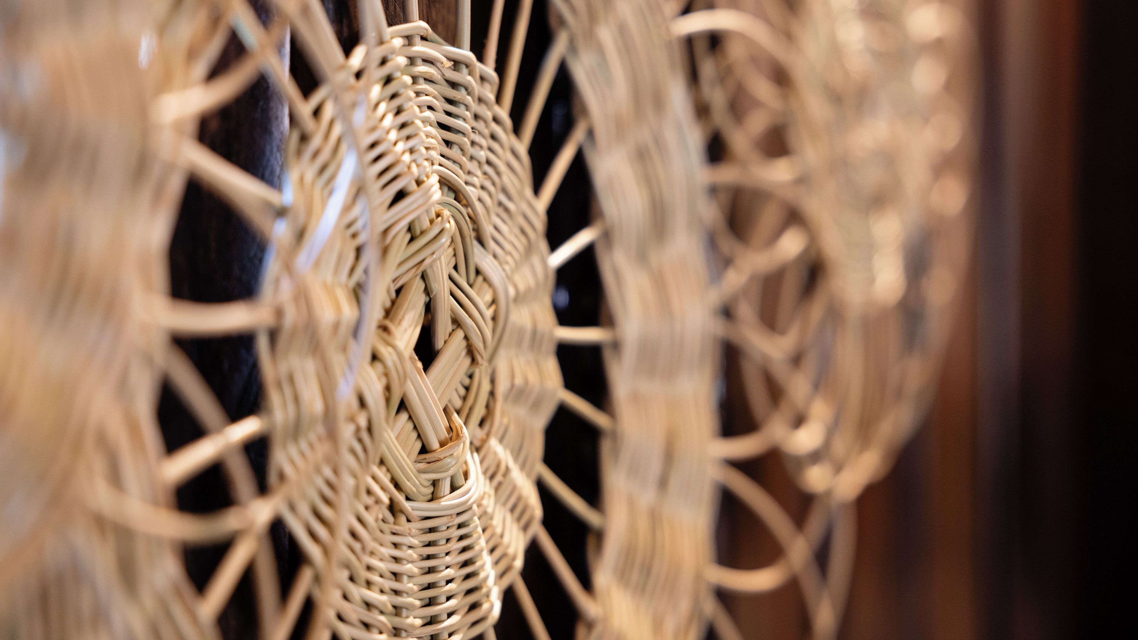 A close-up of a woven wicker structure, likely part of a room's decor.