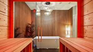 A wooden interior with a sloped ceiling, a central light fixture, and a view into a lower level. - South Lamar Condo / Sauna / Cold Plunge / Pickleball (Austin)
