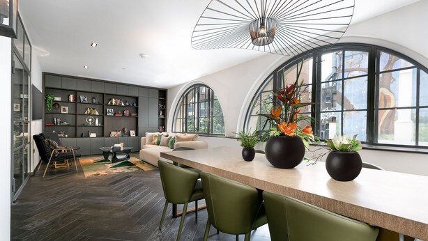 A modern kitchen with a central island, a dining area with chairs, and a large window with a view of the city. - TiPToP Oxford St! Family+Couples Unique Chill Design Haven (London)