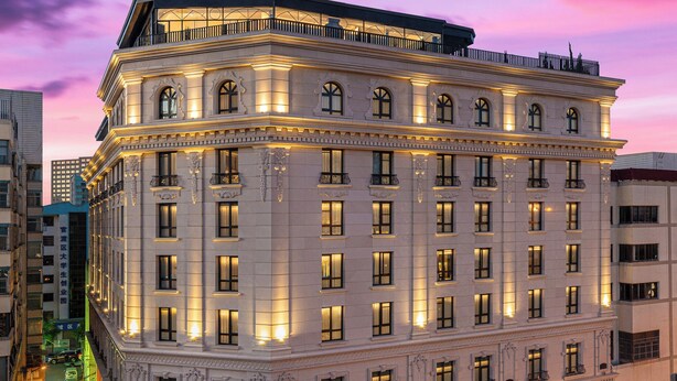A multi-story hotel with a classic architectural style, featuring a grand entrance and multiple windows. - Kunming Kasion Hotel (Kunming)