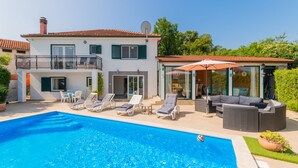 A two-story house with a swimming pool, outdoor seating, and a balcony. - Villa Lara by Villas Guide (Kamenmost)