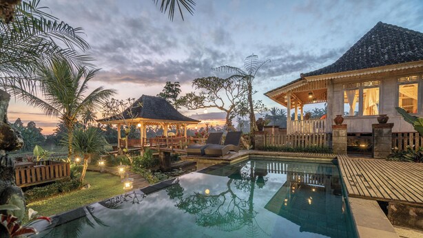 A serene pool area with a gazebo, lounge chairs, and a wooden deck. - Uma Caming Villa Ubud (Payangan)