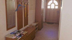 A hallway with a wooden dresser, a mirror, and a wardrobe. - Holiday Home 'Marienblick' with Private Terrace, Private Garden and Wi-Fi (Beeskow)
