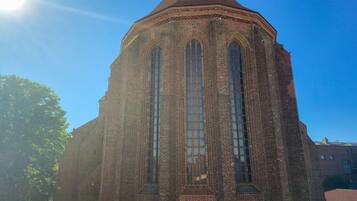 A brick building with a pointed roof and large arched windows.