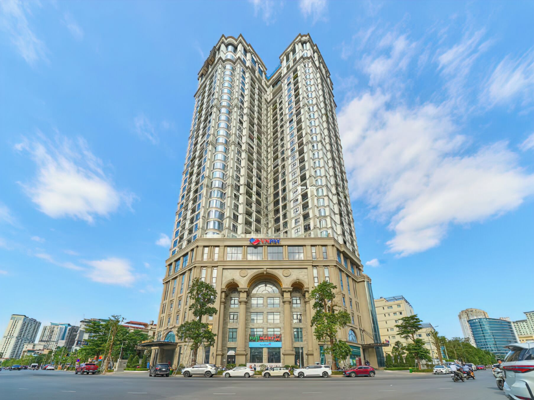 A tall, modern hotel with a distinctive corner design, featuring multiple floors and large windows.