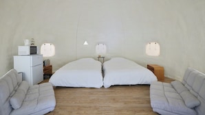 A minimalist room with a bed, two white sofas, a small white cabinet, and a microwave. - ReSchool Nasu Glamp (Nasu)
