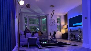 A modern living room with a sofa, coffee table, and floor lamp.