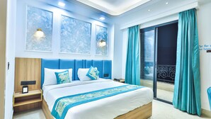 A modern bedroom with a large bed, a nightstand, a wall-mounted light, and a view of the outside balcony. - Orsom Stays Elite Sector 53 (Gurugram)
