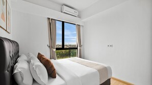 Ein modernes Schlafzimmer mit einem großen Bett, Blick durch ein Fenster und einer Klimaanlage.