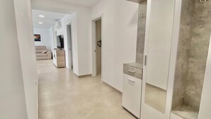 A hallway with a wardrobe, a door, and a small cabinet. - Deluxe Apartment 100 meters from the beach (Benidorm)