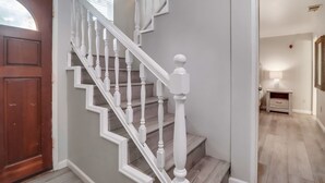 A staircase with white balusters and a wooden door. - Steps to bay & ocean, Belmont Park, A/C family fun (San Diego)