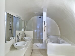 A modern bathroom with a large mirror, two sinks, a bathtub, and a shower. - Sunset View Villa Santorini With Outdoor Jacuzzi (Santorini)