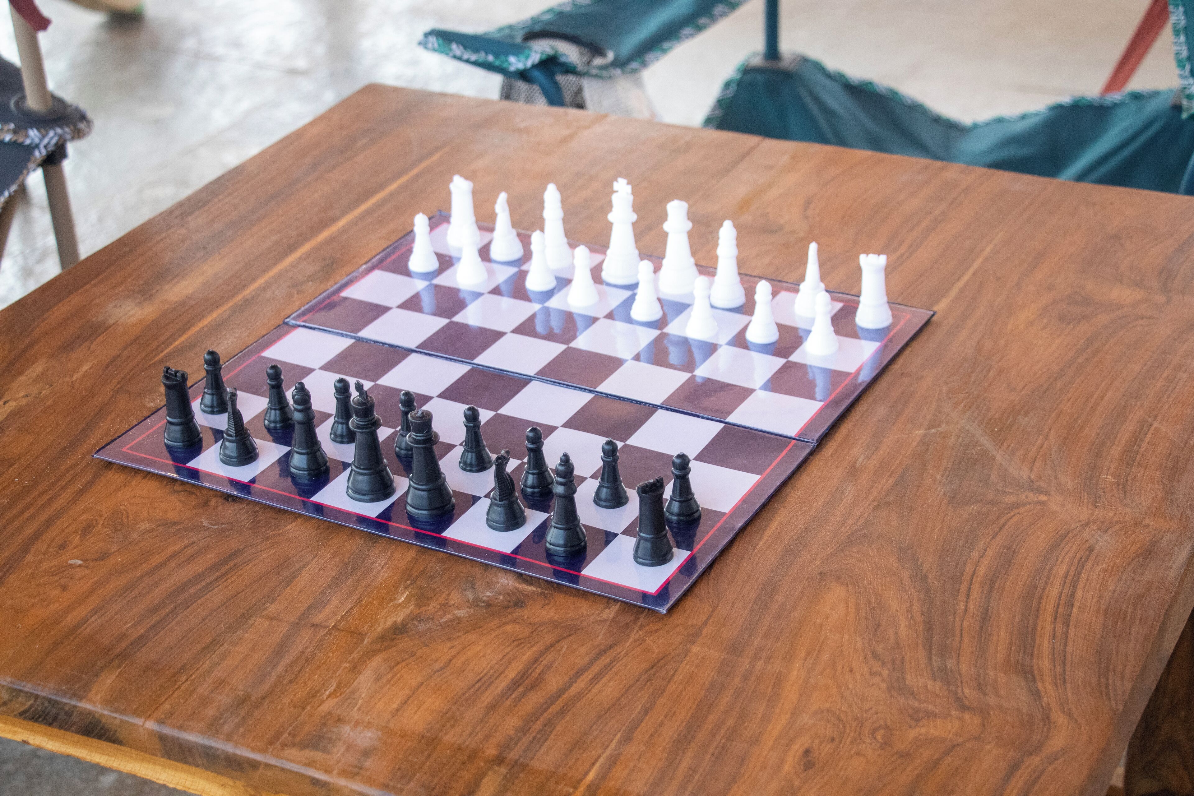 A chessboard on a wooden table.