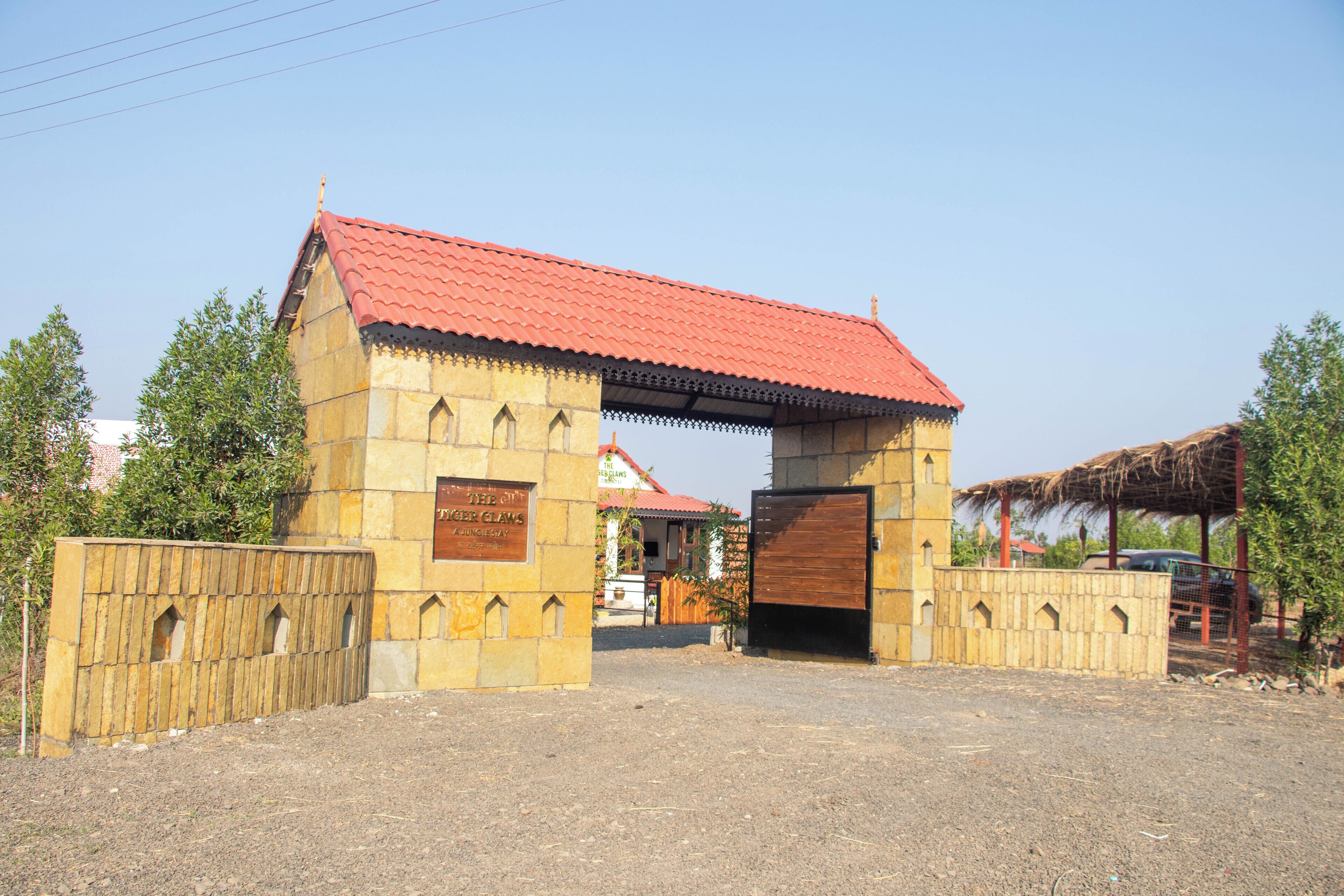 A building with a red-tiled roof and a wooden gate.