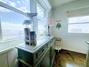 A kitchen with a window, a stove, and a counter with decorative items.
