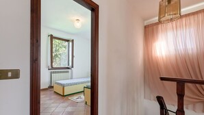 A room with a bed, a window, a radiator, and a staircase. - Stunning private villa for 8 guests with WIFI, TV, patio and pets allowed (Montieri)