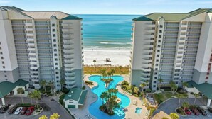 A high-rise hotel with a central pool area and a beach view. - Coastal Hideaway: Cozy Beachfront Studio Sleeps 4 With Stunning Views! (Panama City Beach)