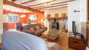 A cozy living room with a sofa, a coffee table, and a fireplace.
