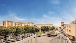 A residential area with multi-story buildings, a central open space with a cross, and a parking lot. - Hotiday Apartments La Spezia (La Spezia)