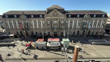 A large historic building with a central entrance, multiple windows, and a prominent roof.