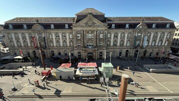 Un edificio histórico grande con una entrada central, varias ventanas y un techo destacado.