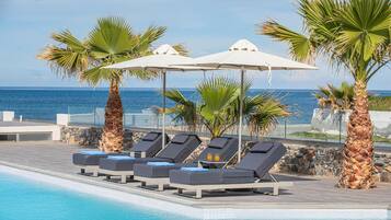 Seasonal outdoor pool, open 9:00 AM to 7:00 PM, pool umbrellas