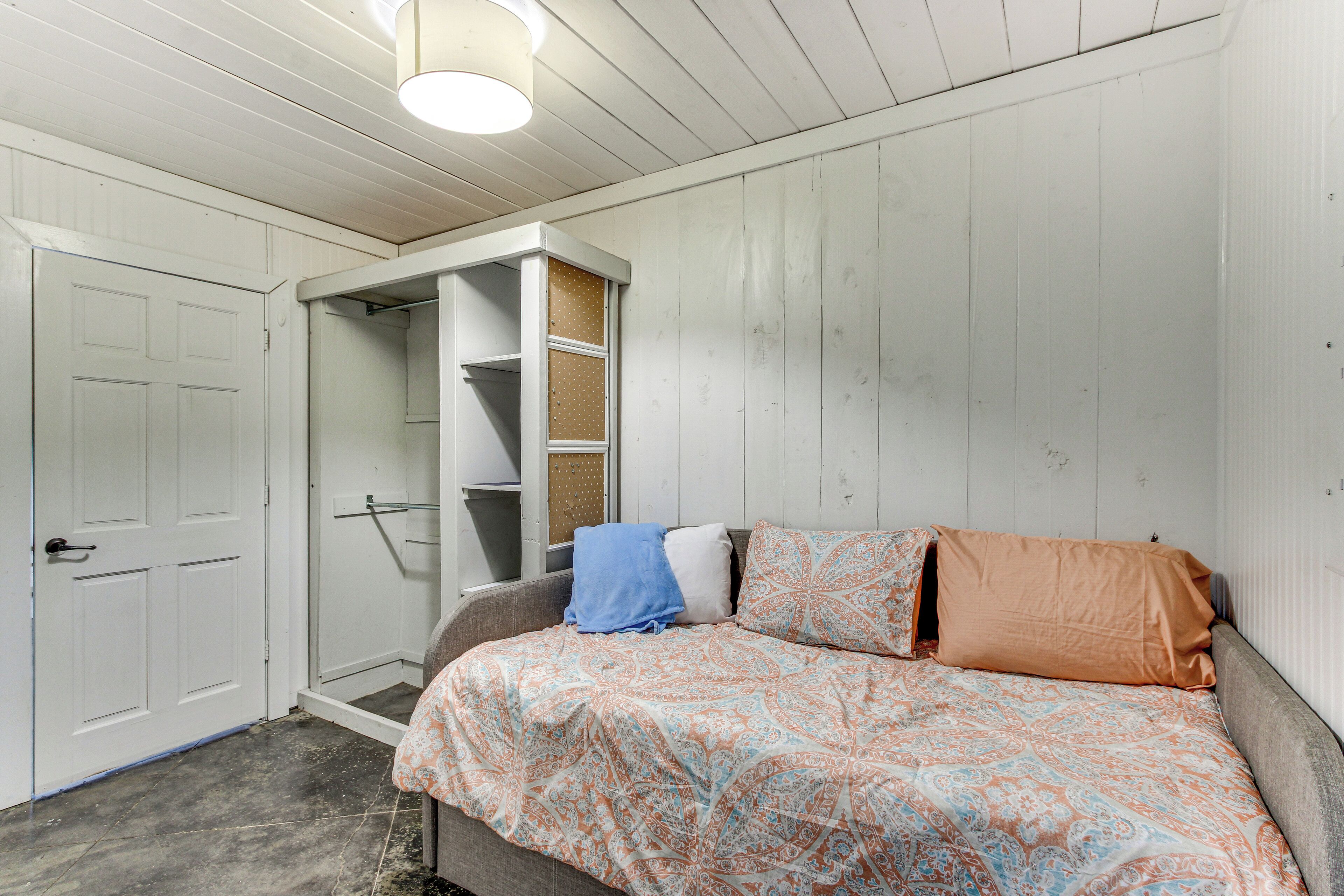 A bedroom with a bed, a wardrobe, and a closet.