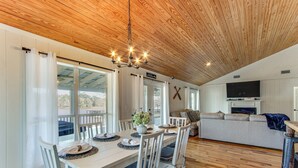 A dining area with a wooden ceiling, white walls, and a large window. - Tranquil Gantt Lake Home w/ Deck & Patio! (Andalusia)