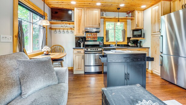 A modern kitchen with wooden cabinets, stainless steel appliances, and a wooden ceiling. - Cle Elum Cabin on the Yakima River! (Cle Elum)