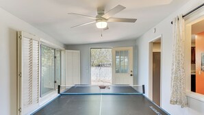 A room with a ping pong table, a ceiling fan, and a view of the outdoors. - Private Oro Valley Home w/ 130 Mi Bike Path Nearby (Oro Valley)