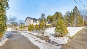 A residential street with houses, snow-covered ground, and evergreen trees. - 3 Mi to Cuyahoga Valley NP: Fairlawn Family Home! (Akron)