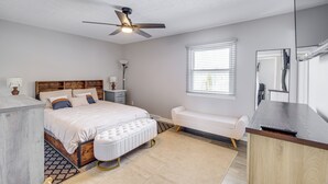 A bedroom with a bed, bedside table, lamp, and a ceiling fan. - 3 Mi to Cuyahoga Valley NP: Fairlawn Family Home! (Akron)