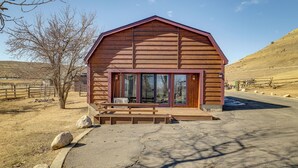 A wooden cabin with a sloped roof, large windows, and a front porch. - 2 Mi to Main Street: Mtn-view Escape in Lander! (Lander)