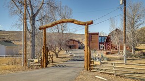A rustic wooden archway leading to a cabin with a dirt path. - 2 Mi to Main Street: Mtn-view Escape in Lander! (Lander)