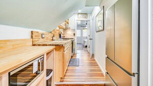 A narrow kitchen with wooden countertops, a built-in oven, and a refrigerator. - Boat Dock & Ramp: Upwind Acres Guesthouse! (Aurora)