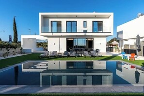 A modern two-story house with a swimming pool in the foreground. - Styla Protaras Luxury Villas (Protaras)