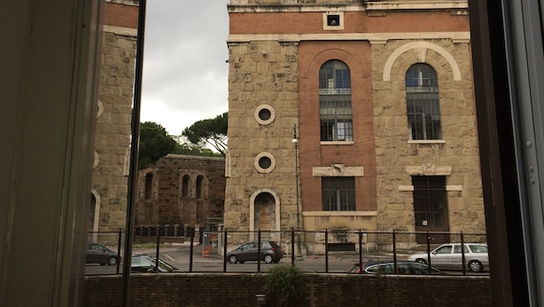 A historic building with arched windows and a plaque reading "S P O R ANNO MCXXXIII". - Casa Tua a Porta Maggiore (Rome)