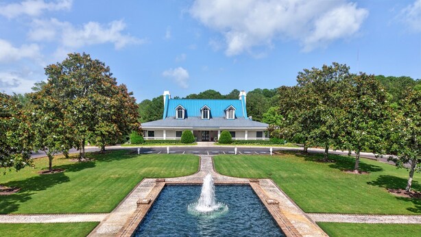 A large building with a blue roof, a central fountain, and well-maintained lawns. - 11d True Blue Golf Haven Ii 2 Bedroom Home (Pawleys Island)