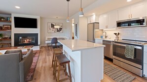 A modern kitchen with white cabinetry, stainless steel appliances, and a central island. - Seventh Mt 1417/1418 1 Bedroom Condo (Bend)